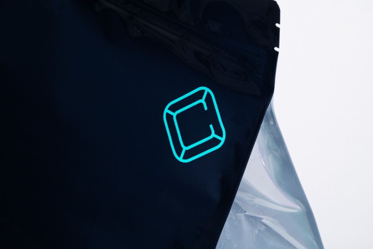 Calyx Cure bag with branding on dark background