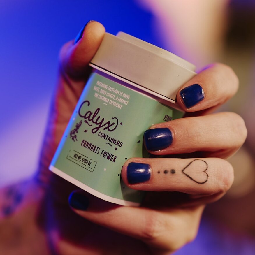 Calyx custom-printed label on a Dram container