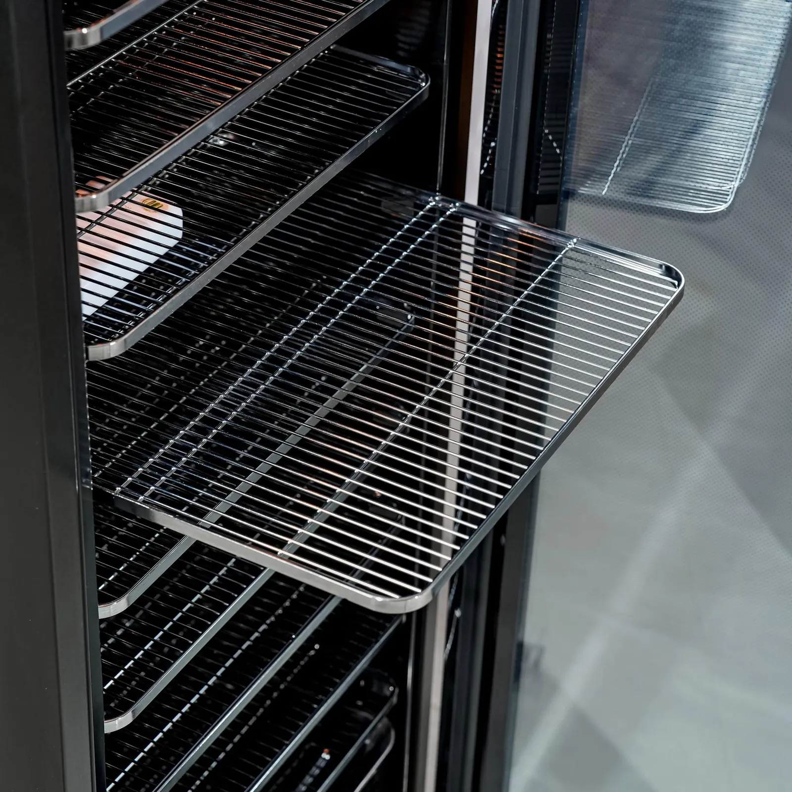 Stainless rack sliding out of the cabinet